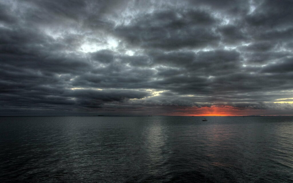 Stormy Seascape HD Wallpaper: Clouds, Calm Ocean & Sunlight