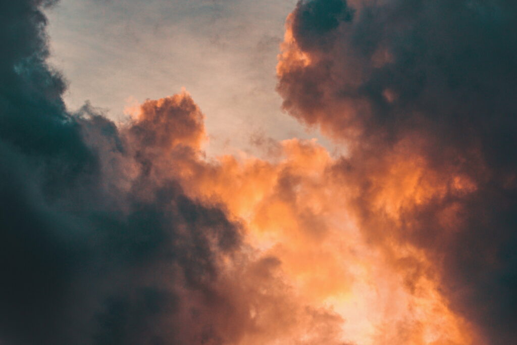 Dramatic Sky HD Wallpaper: Golden Sunset over Dark Clouds Background