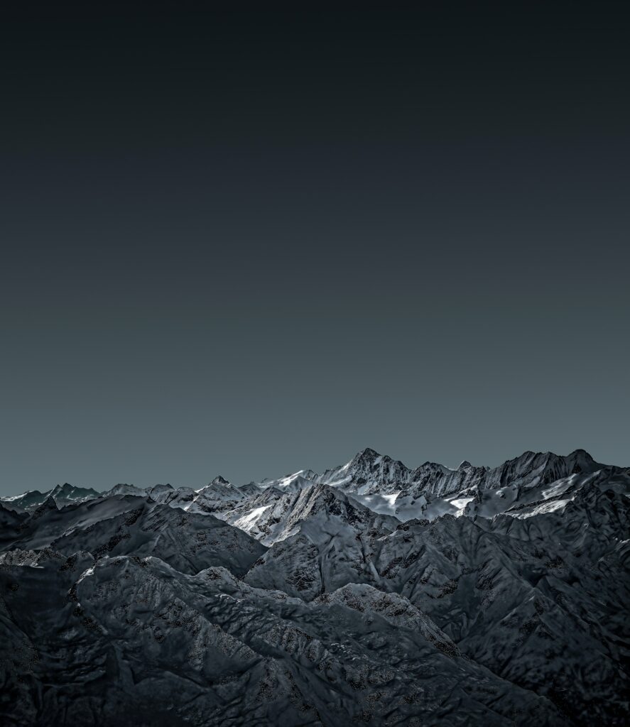 Snow-covered rugged mountain range under dusky sky detailed landscape nature wallpaper background