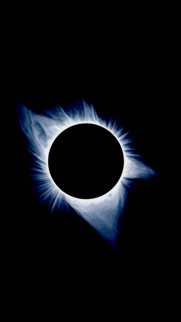 Solar eclipse viewed through black hole with glowing corona minimalist cosmic wallpaper background