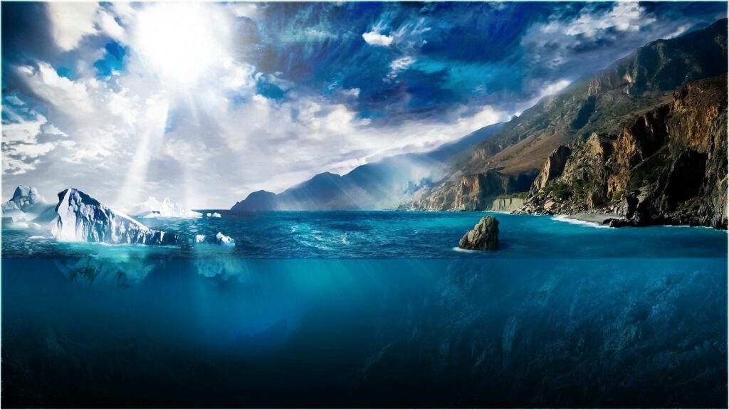 Dramatic sunlight over blue ocean with ice floes cliffs and deep underwater view wallpaper background