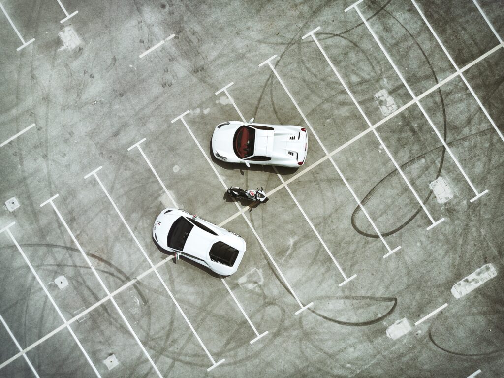 Luxury Sports Cars & Ducati: Elegant Top View Parking Lot Wallpaper