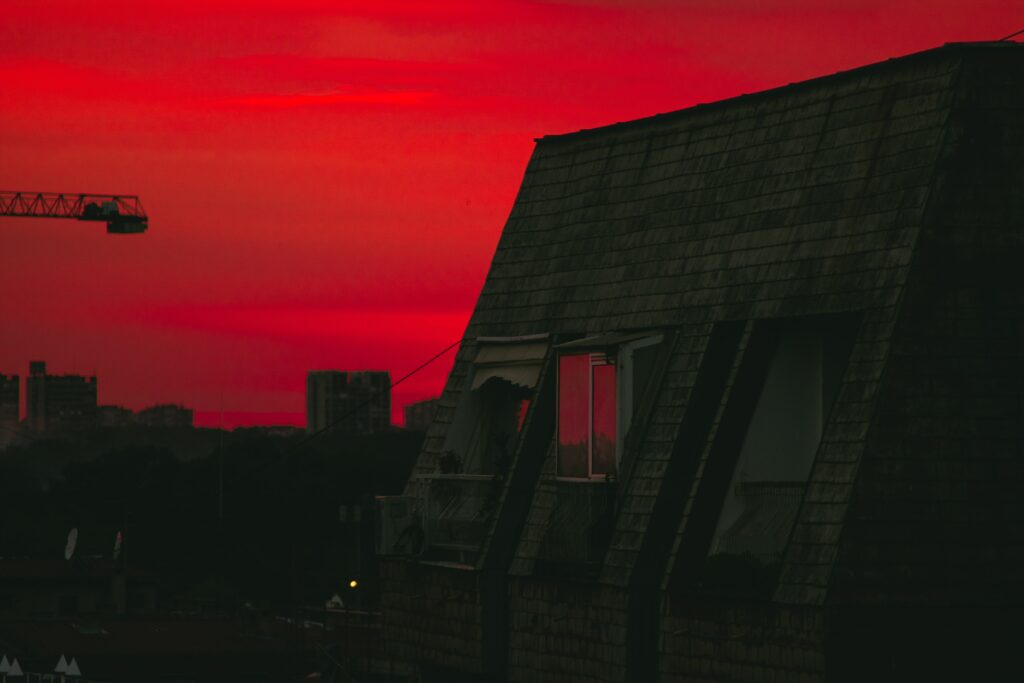Twilight Wallpaper: Dramatic Rooftop and Fiery Sunset Scene