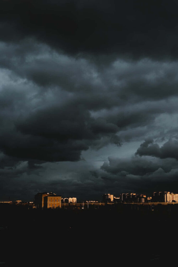 Dramatic Dark Cloud Wallpaper Over City Skyline - Intense Mood Background