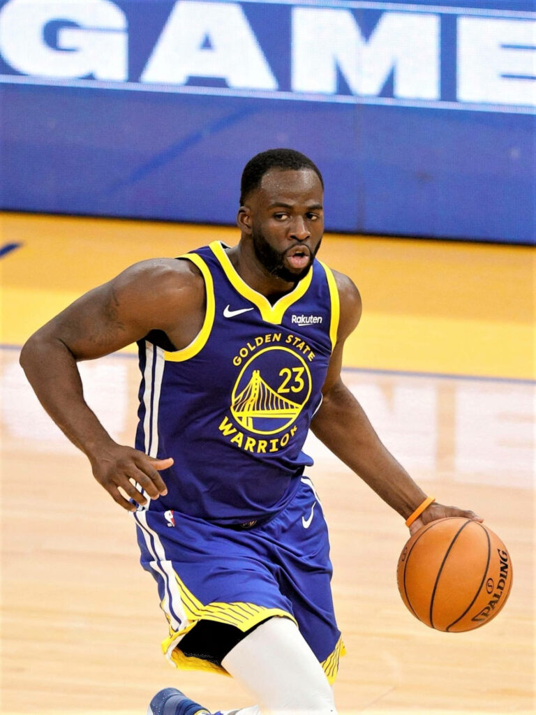 Draymond Green fastbreak in Golden State Warriors uniform dynamic basketball wallpaper background