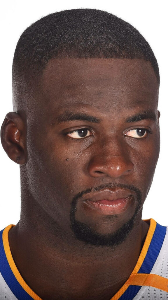 Close-up of Draymond Green showing intense focus in vibrant blue and yellow basketball uniform wallpaper