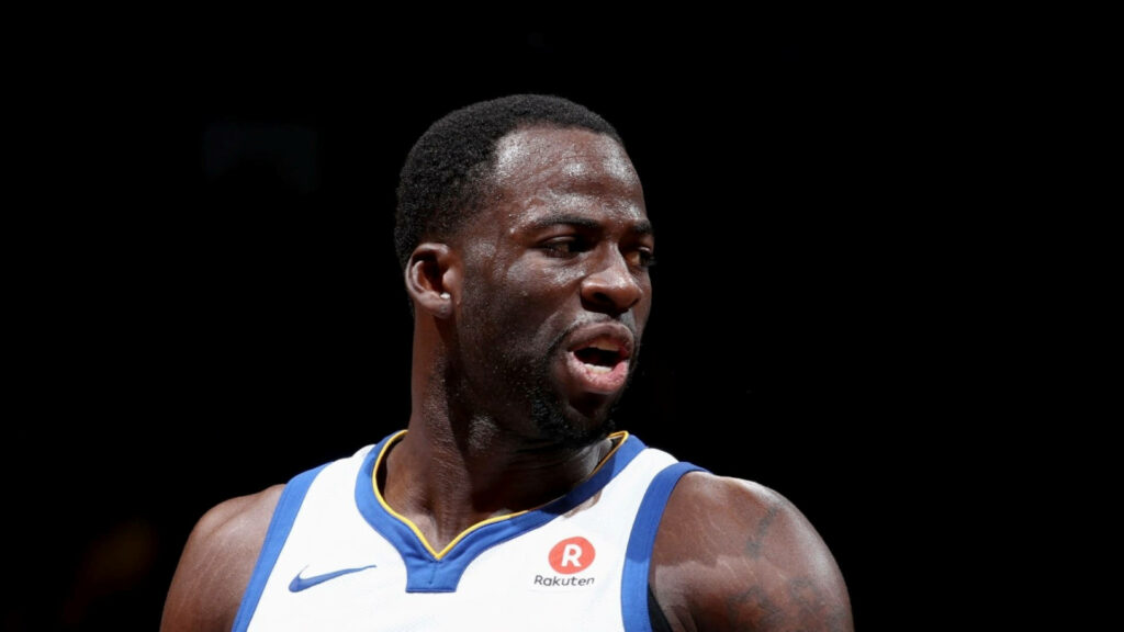 Draymond Green intense basketball game moment Golden State Warriors jersey dynamic athlete Wallpaper