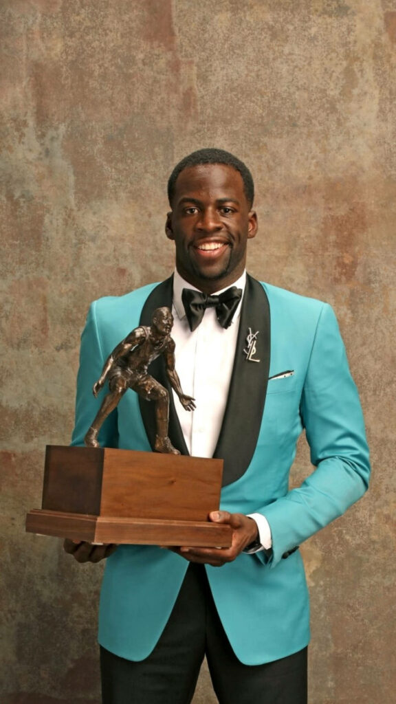 Draymond Green in turquoise tuxedo holding NBA Award 2017 celebrating achievement and style Wallpaper