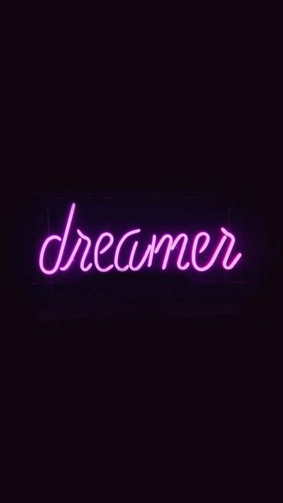 Neon pink dreamer cursive sign on black background modern aesthetic wallpaper background design