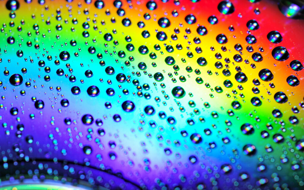 Rainbow Reflection: Mesmerizing Close-up of Glistening Raindrops on a Stunning Cool Background Wallpaper
