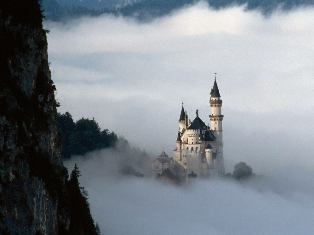 Neuschwanstein Castle: Dreamy Foggy Wallpaper with Lush Greenery