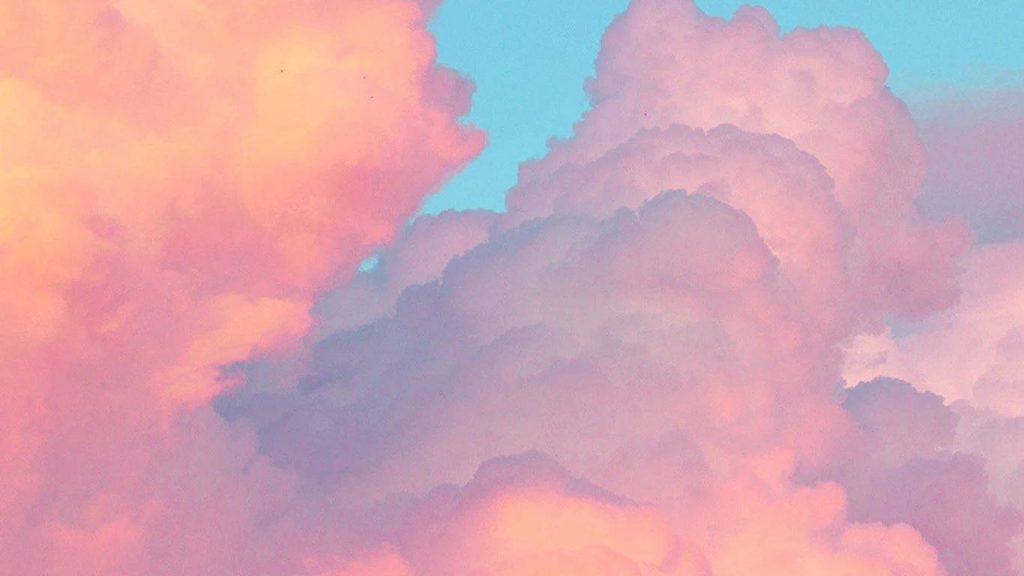 Dreamy pastel cloud wallpaper with fluffy cumulus clouds in soft pink peach and blue hues