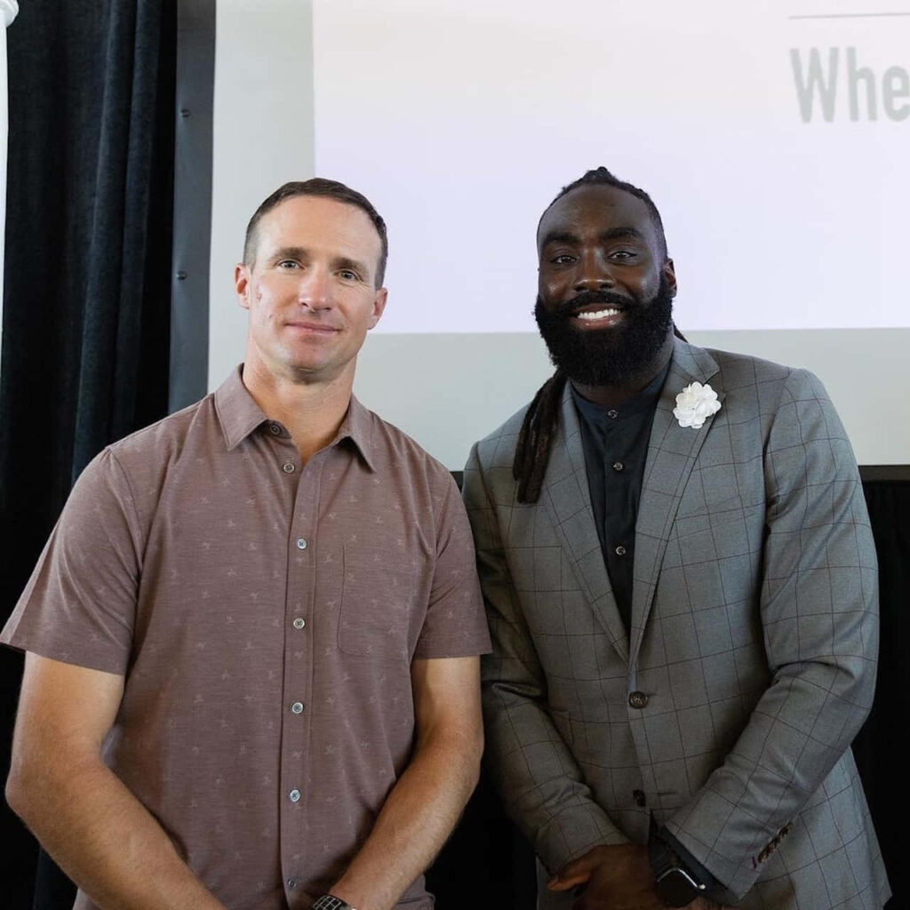 NFL quarterback Drew Brees and linebacker Demario Davis together at Devoted Dreamers Academy event Wallpaper