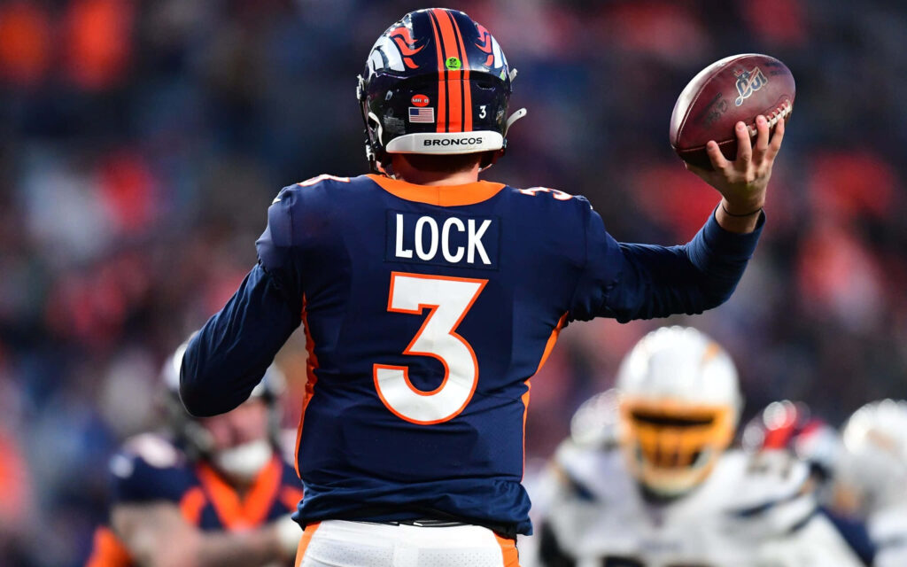Drew Lock Broncos quarterback number 3 in action under stadium lights vibrant NFL game wallpaper