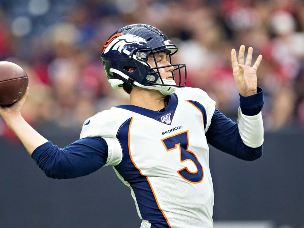 Drew Lock Denver Broncos quarterback in white blue uniform throwing football action wallpaper