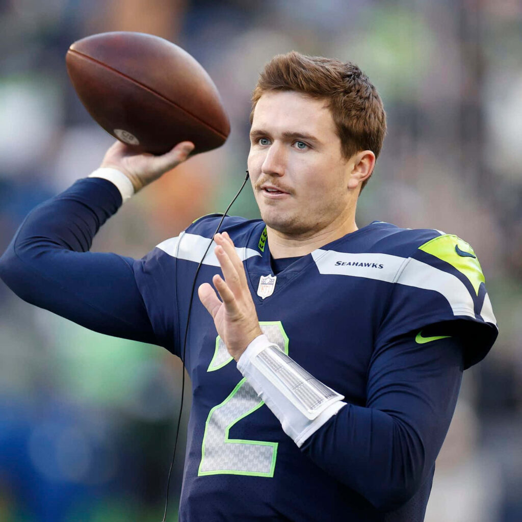 Drew Lock Seattle Seahawks quarterback in action throwing football vibrant team colors wallpaper