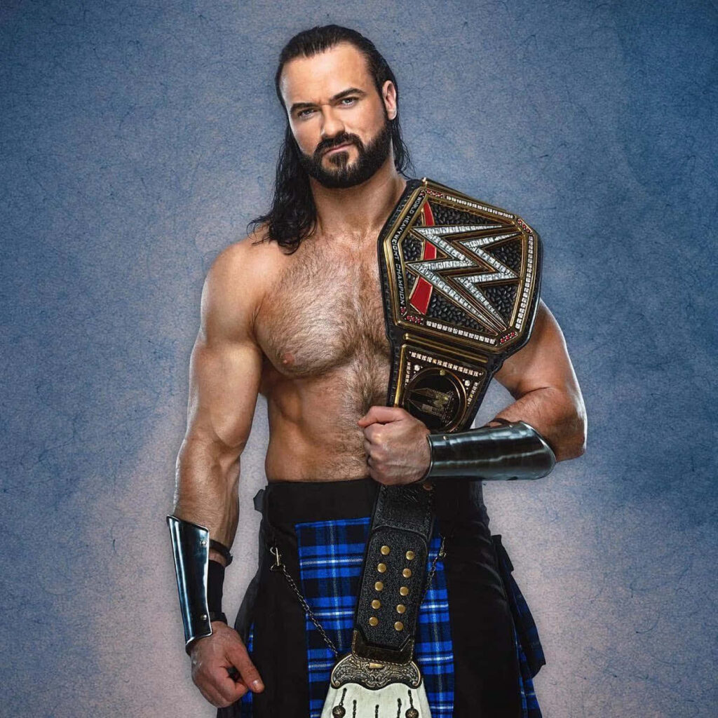 Drew McIntyre with Intercontinental Championship belt on shoulder blue textured background wallpaper