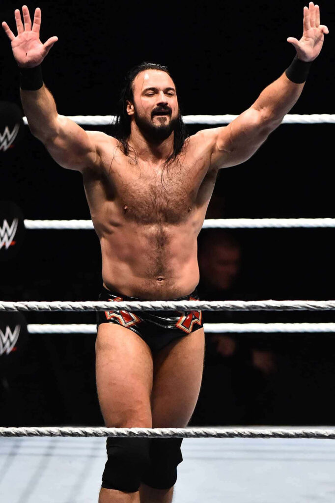 Drew McIntyre victorious in WWE ring strong physique Royal Rumble intense wrestling moment Wallpaper