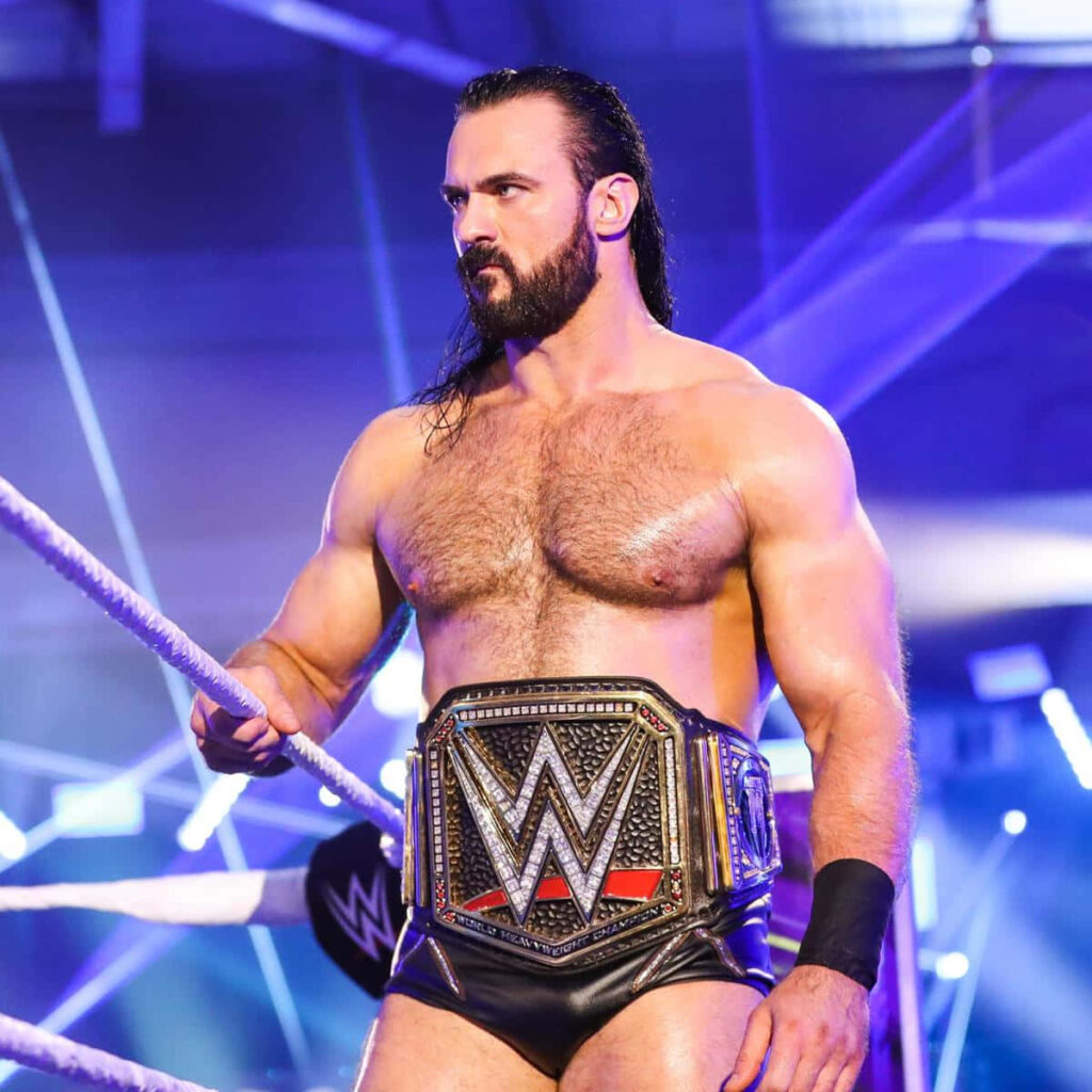 Drew McIntyre WWE Champion in ring with intense focus dramatic lighting vibrant wrestling background Wallpaper