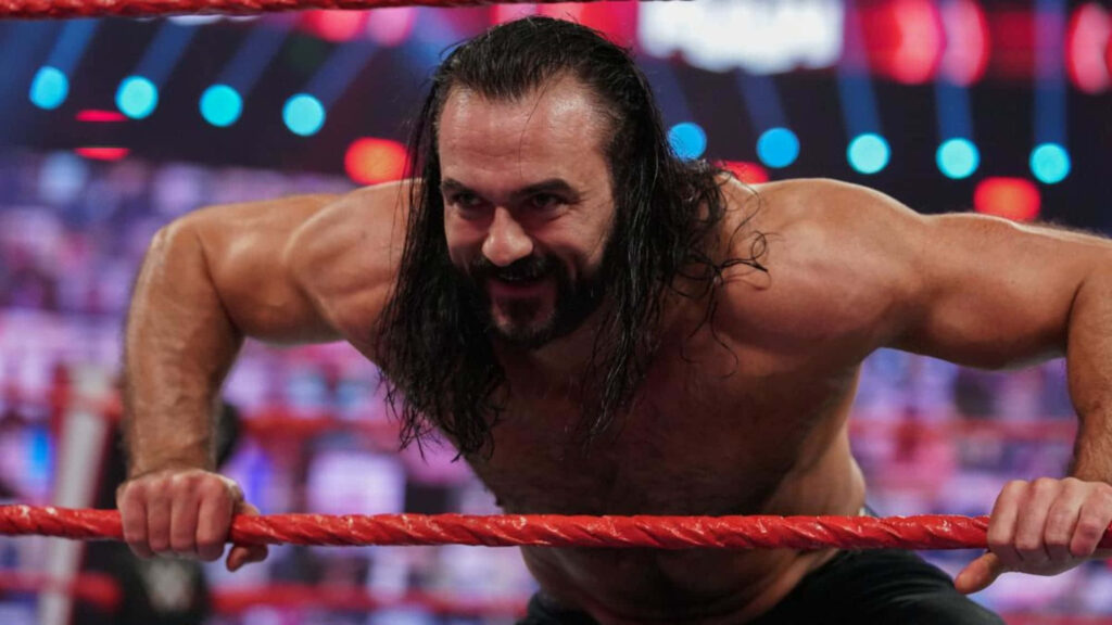 Drew McIntyre wrestling wallpaper intense action shot gripping red ropes with confident smile