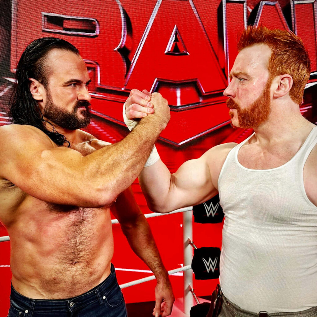 Drew McIntyre and Sheamus united in WWE ring with intense expressions and red RAW backdrop Wallpaper