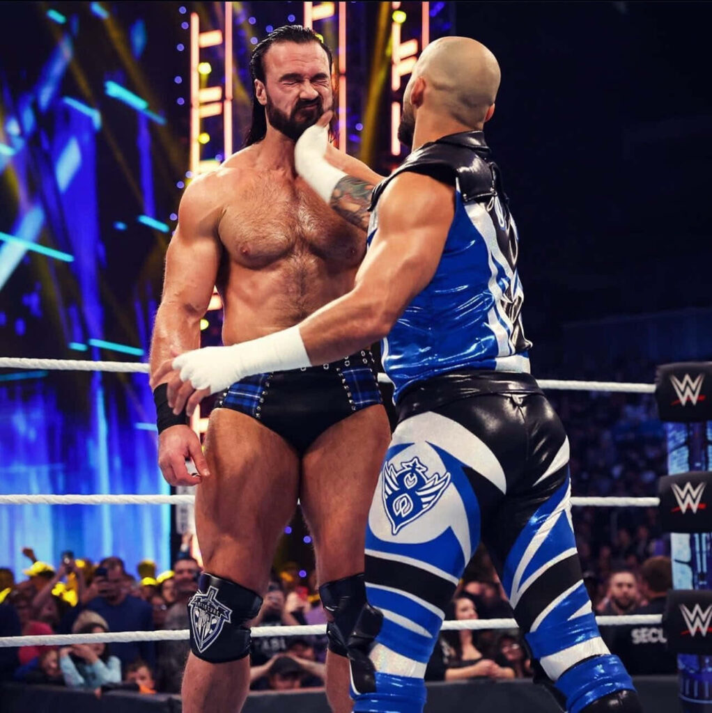 WWE Drew McIntyre and Ricochet high energy wrestling match vivid lighting dynamic action wallpaper
