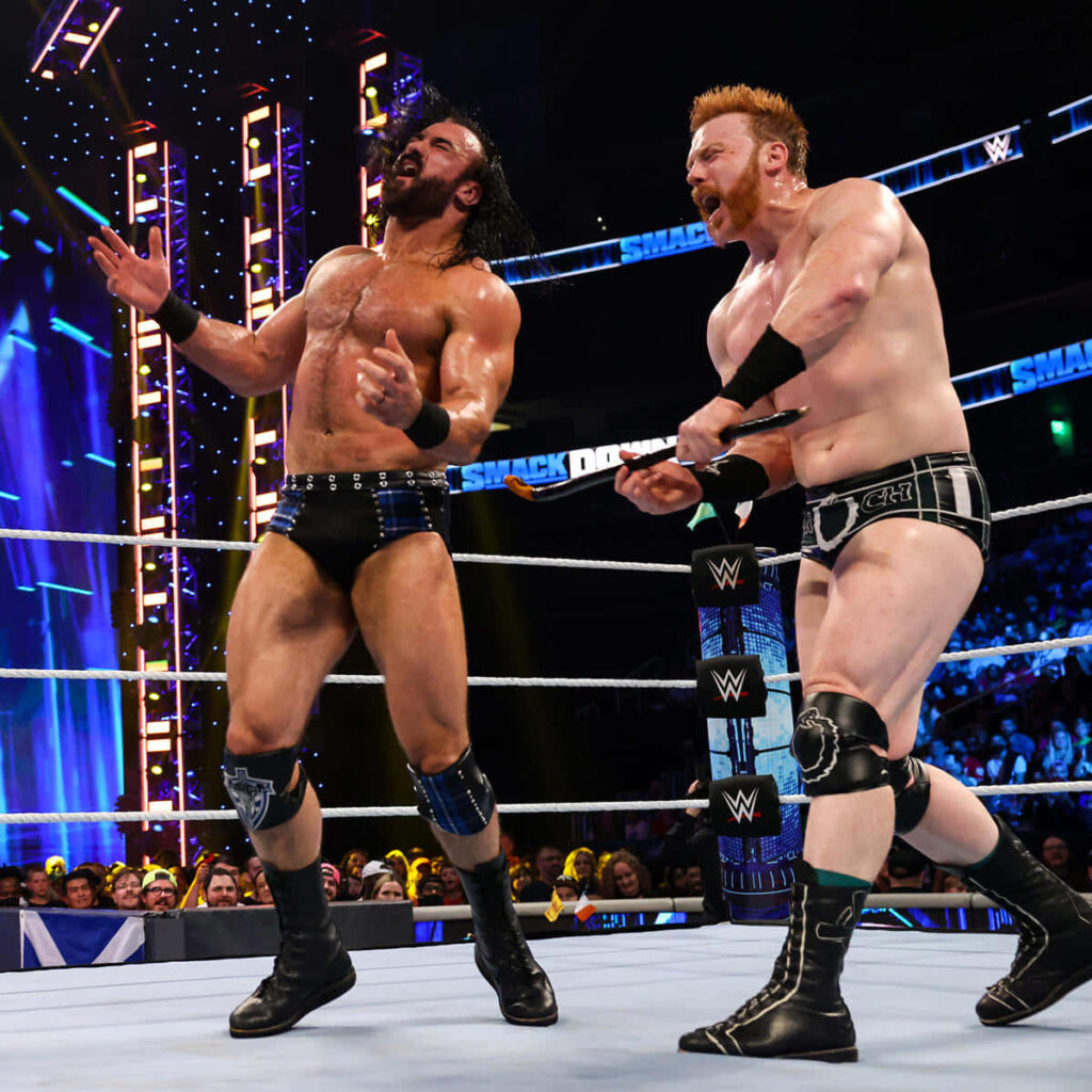 Drew McIntyre and Sheamus WWE SmackDown intense match action vivid arena lights wrestling rivalry Wallpaper