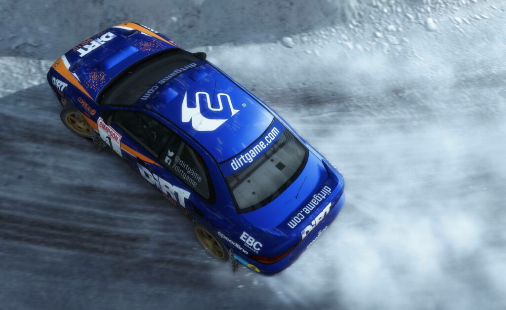 Snow-Covered Drift King: The Metallic Blue Subaru Impreza Unleashes its Raw Power in Dirt Rally Wallpaper