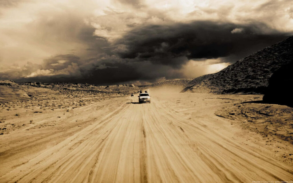 Safari Driving Adventure: A Dusty Road under the Dusky Sky Wallpaper