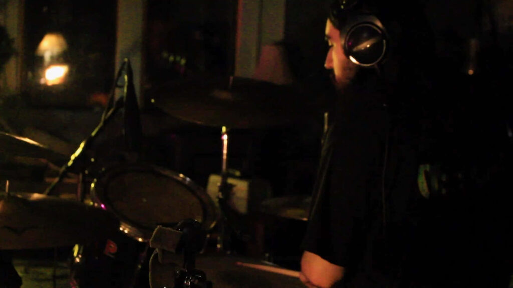 Drummer in Dim Light: Moody Wallpaper Background for Music Lovers