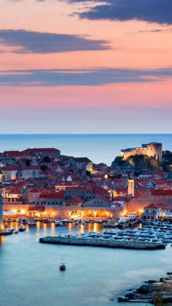 Dubrovnik Croatia historic seaport with terracotta rooftops stone walls and sunset harbor Wallpaper