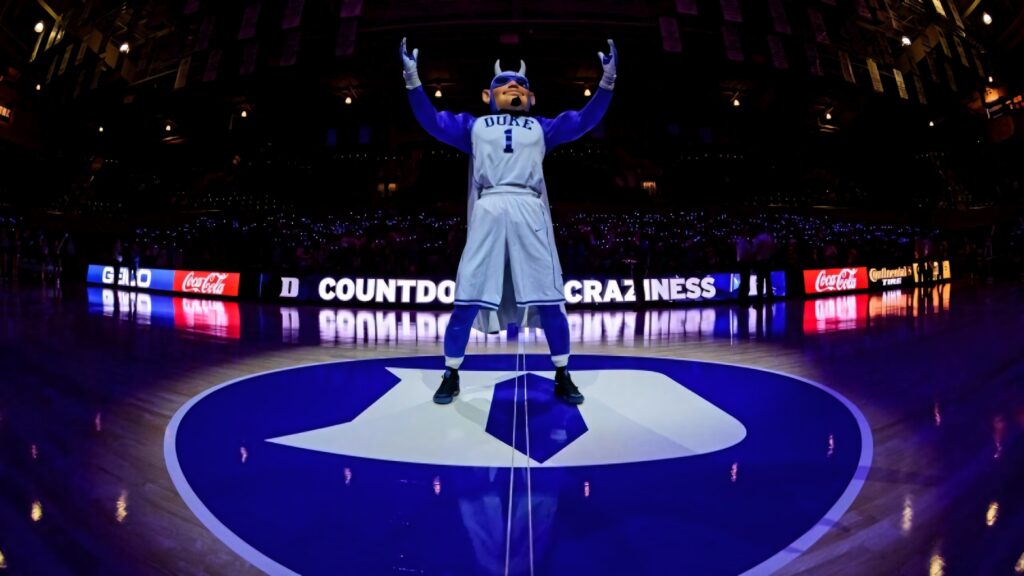 Duke Blue Devils mascot at center court vibrant arena lights energetic basketball fans wallpaper