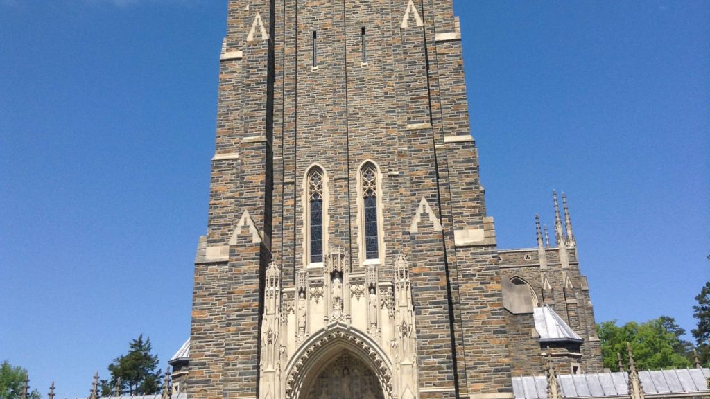 Duke University Chapel stone tower in bright daylight with clear blue sky Collegiate Gothic design Wallpaper