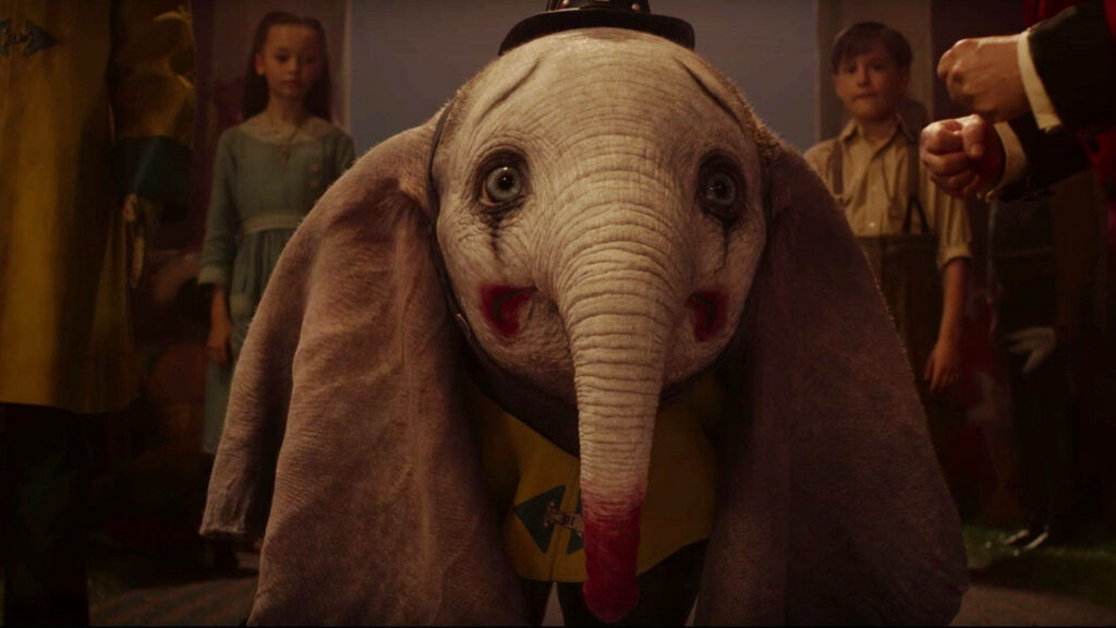 Dumbo 2019 live-action wallpaper with expressive blue eyes oversized ears circus scene background