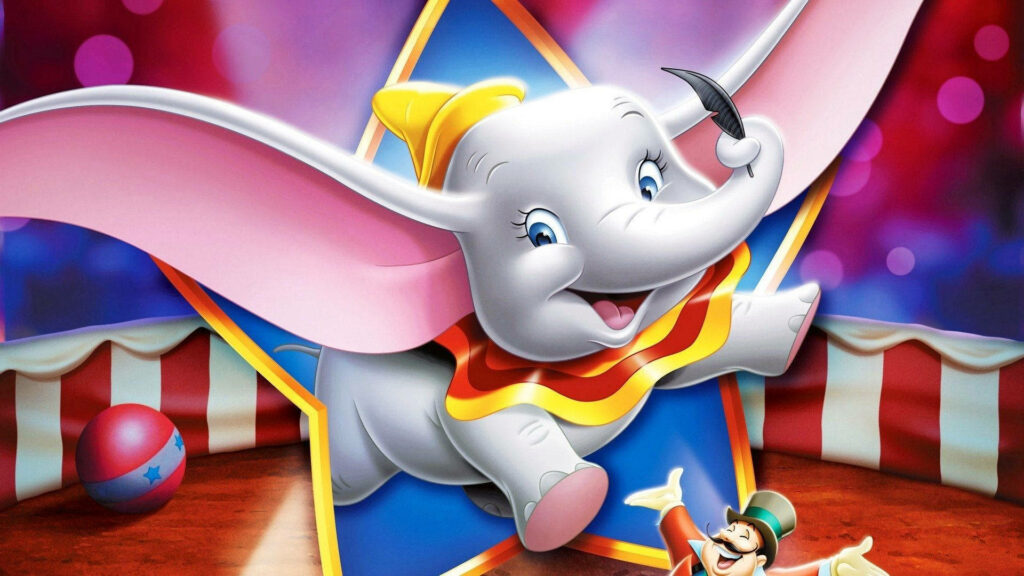 Dumbo elephant soaring in colorful circus star frame with yellow hat vibrant festive wallpaper