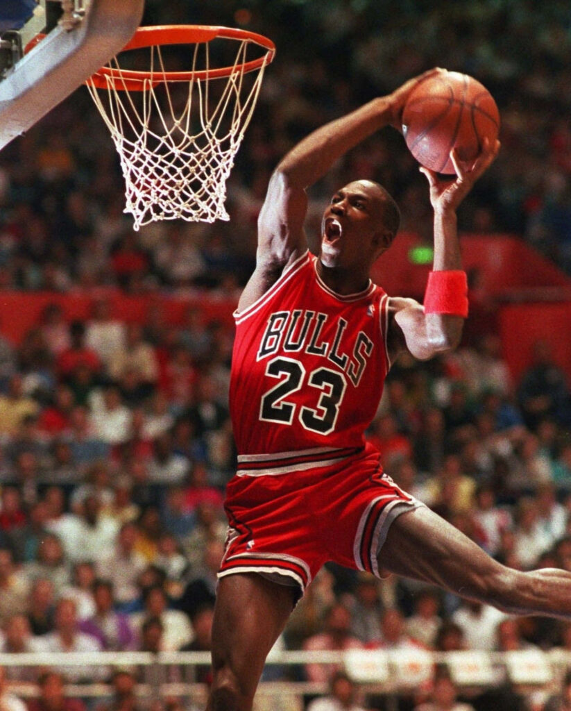 Gravity-Defying Slam: Michael Jordan Dominates the Game with an Epic Dunk Wallpaper
