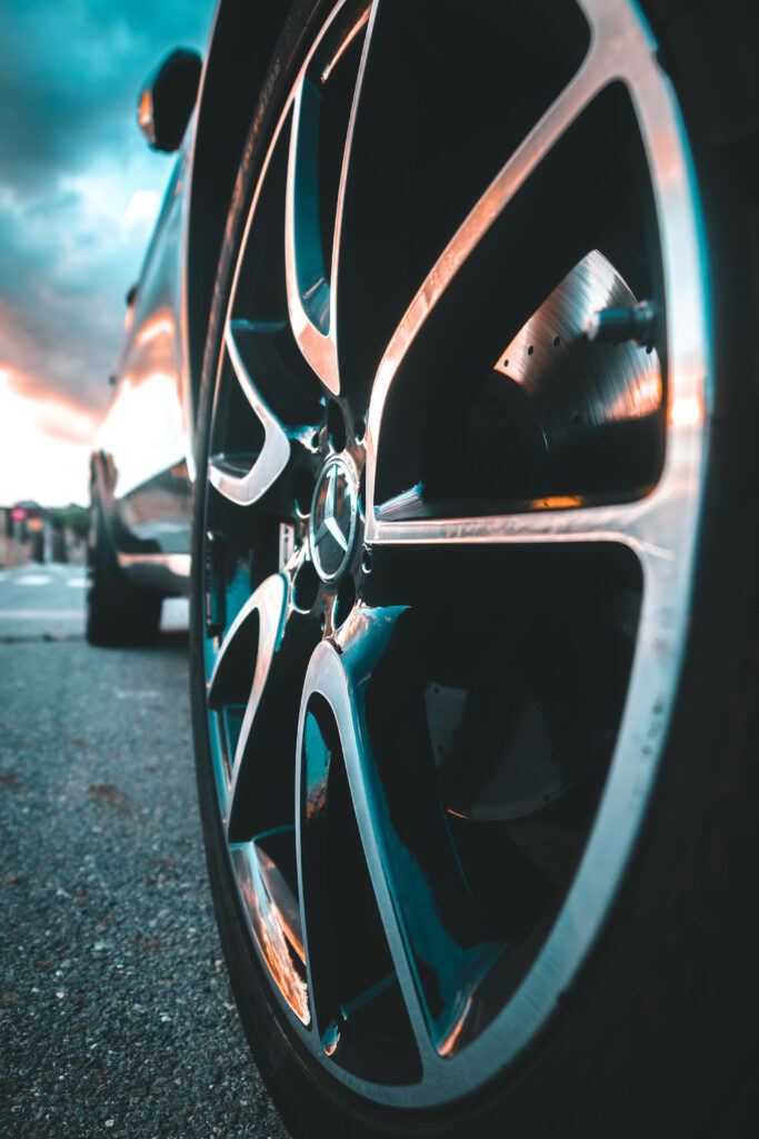 Dusk Sky Reflection on AMG C-Class Rear Tire: Stunning iPhone Background Photo for Mercedes-Benz Enthusiasts Wallpaper