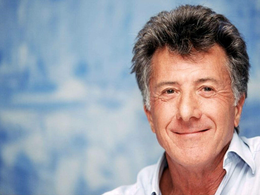 Dustin Hoffman close-up portrait with gentle smile soft blue background iconic actor wallpaper