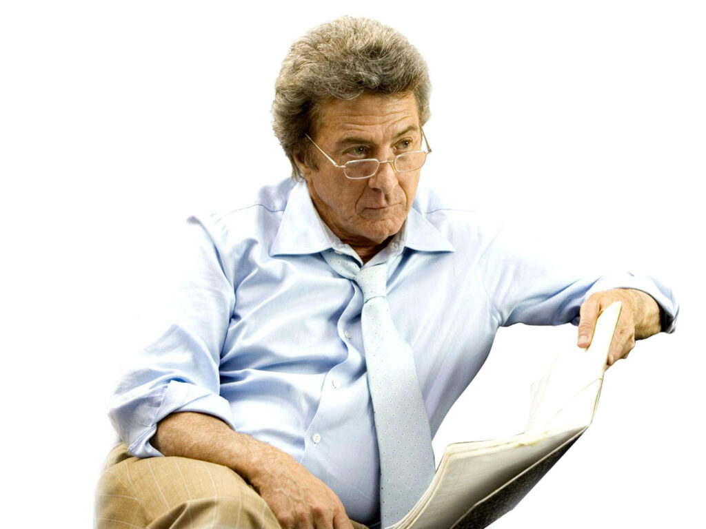 Dustin Hoffman as Professor Jules Hilbert reading intently in blue shirt and glasses on white background Wallpaper