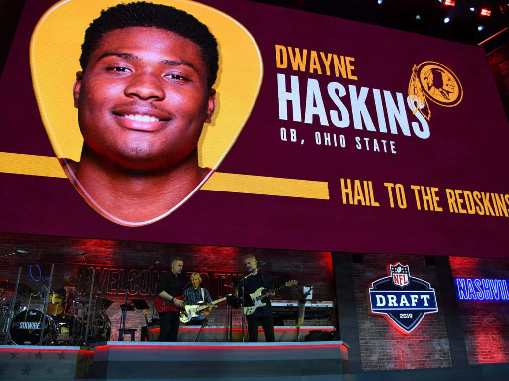 Dwayne Haskins 2019 NFL Draft wallpaper with Ohio State badge on gold and burgundy background