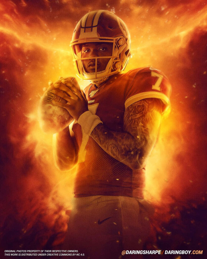 Dwayne Haskins in football uniform glowing with fiery orange light ready for action on field wallpaper