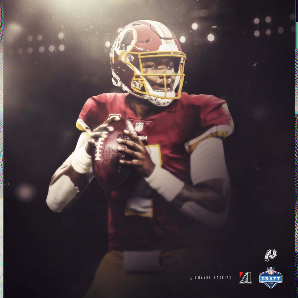 Dwayne Haskins in Washington Redskins uniform focused during game with dramatic dark background Wallpaper