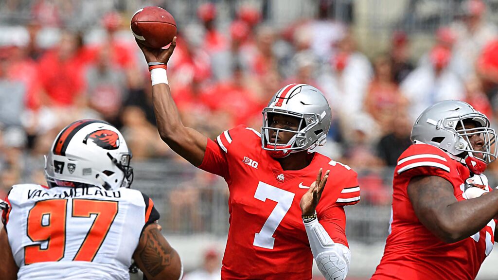 Dwayne Haskins Ohio State football quarterback throwing ball in intense college game action Wallpaper
