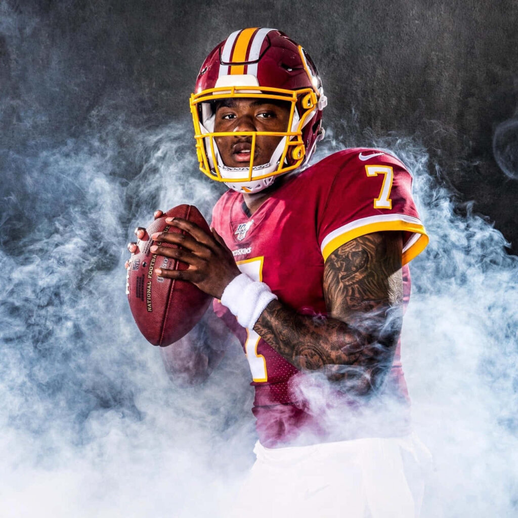 Dwayne Haskins in Washington Football Team uniform with smoke backdrop intense quarterback pose Wallpaper