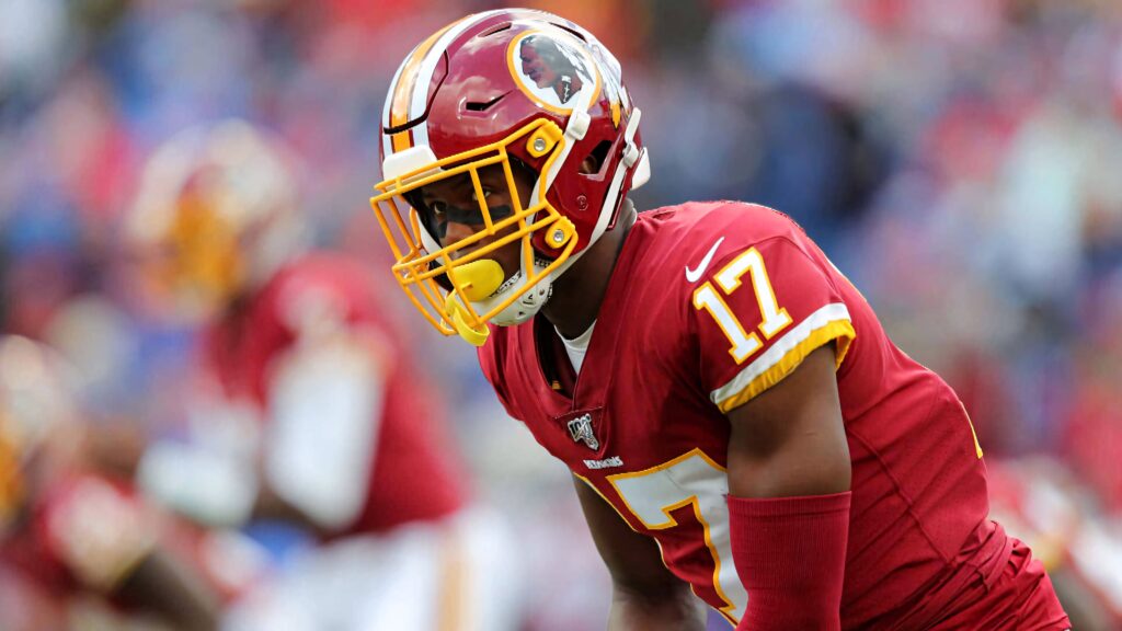 Dwayne Haskins in burgundy and gold Washington jersey mid-game intense football action wallpaper