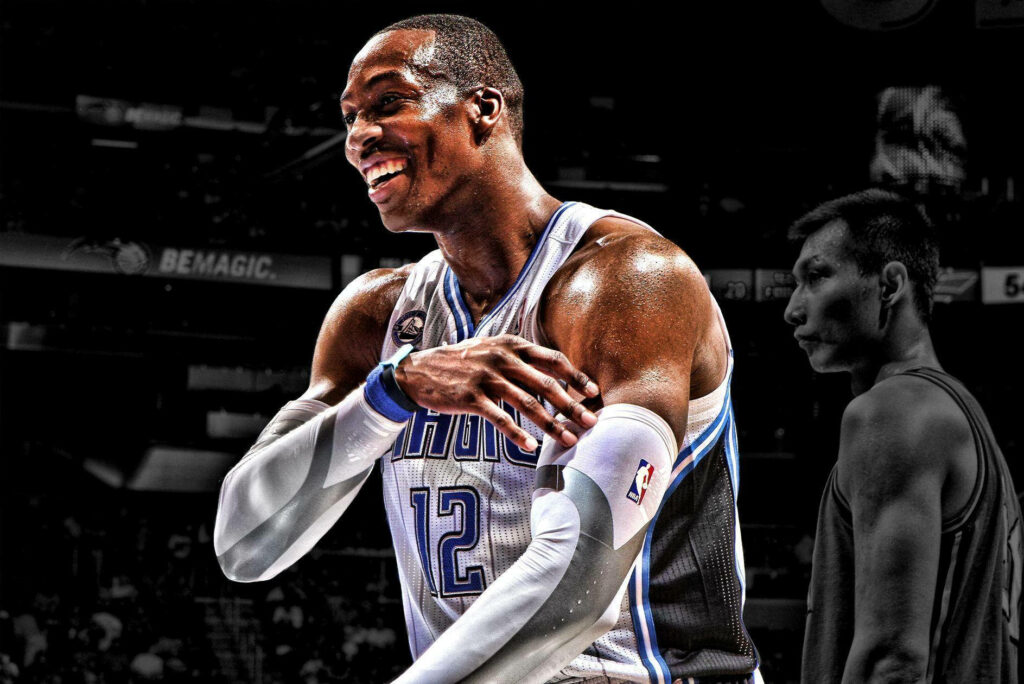 Dwight Howard smiling in Orlando Magic jersey with vibrant lighting and dramatic black and white background Wallpaper