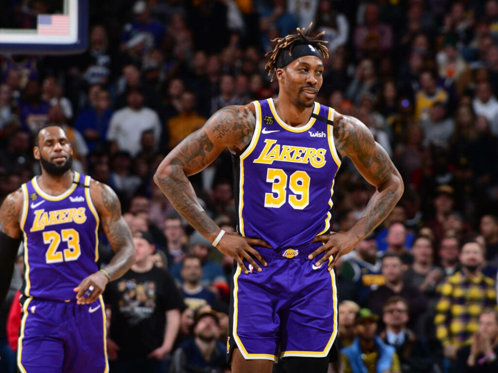 Dwight Howard and LeBron James in Lakers purple gold uniforms on court during intense NBA game Wallpaper