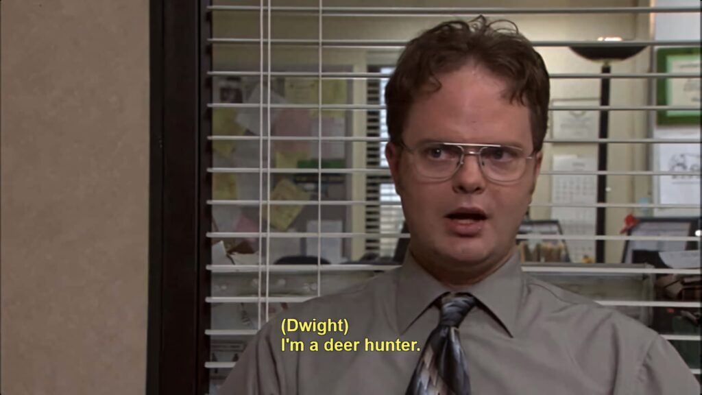 Dwight Schrute from The Office in signature office attire with glasses serious expression wallpaper