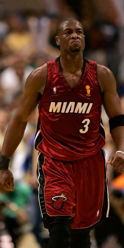 Dwyane Wade in red Miami Heat jersey number 3 fierce pose NBA star blurred arena background Wallpaper