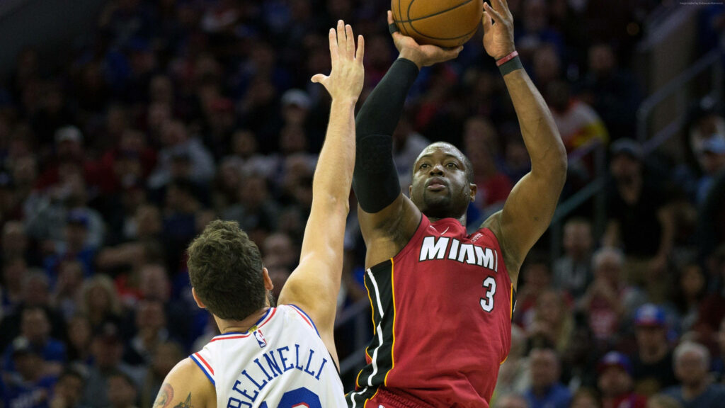 Dwyane Wade Miami Heat NBA Finals mid-air three-point shot intense action vibrant arena wallpaper
